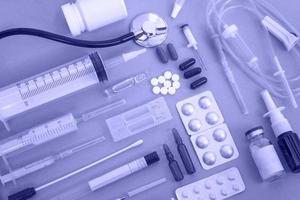 Flat lay of various medical supplies on blue background, copy space photo