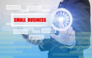 business woman touch small business text on visual screen, business concept photo