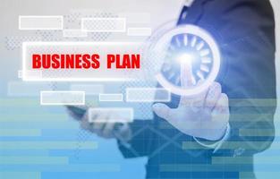 business woman touch BUSINESS PLAN text on visual screen, business concept photo