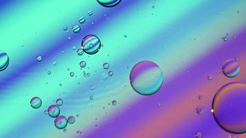 Abstract Colorful Food Oil Drops Bubbles and spheres Flowing on Water Surface, macro Videography video