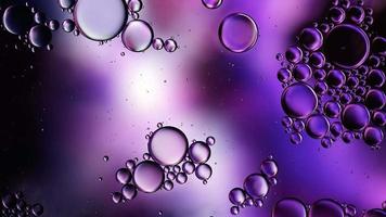 Abstract Colorful Food Oil Drops Bubbles and spheres Flowing on Water Surface, macro Videography video