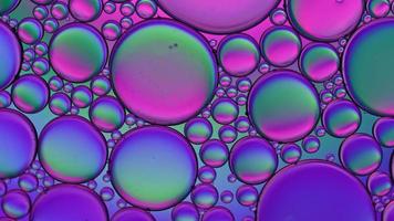 Abstract Colorful Food Oil Drops Bubbles and spheres Flowing on Water Surface, macro Videography video