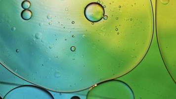 Abstract Colorful Food Oil Drops Bubbles and spheres Flowing on Water Surface, macro Videography video