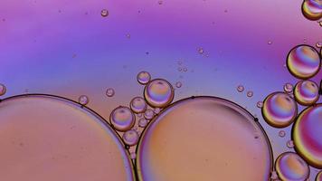 Abstract Colorful Food Oil Drops Bubbles and spheres Flowing on Water Surface, macro Videography video