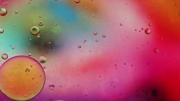 Abstract Colorful Food Oil Drops Bubbles and spheres Flowing on Water Surface, macro Videography video