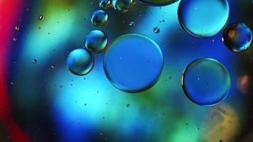 Abstract Colorful Food Oil Drops Bubbles and spheres Flowing on Water Surface, macro Videography video