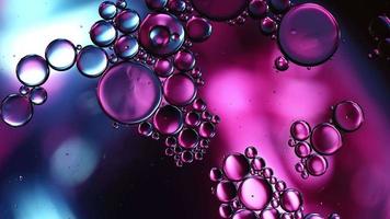 Abstract Colorful Food Oil Drops Bubbles and spheres Flowing on Water Surface, macro Videography video