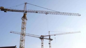 Construction Cranes on the background of a blue Sky, Wroclaw Poland video