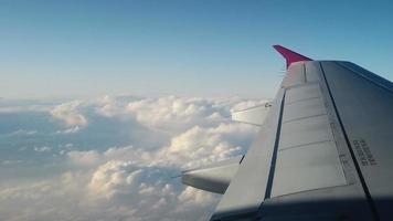 Wing of an airplane flying above the clouds video