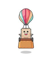 ticket mascot riding a hot air balloon vector