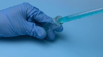 Taking a blue liquid is taken with a pipette from a small flask. The concept of medical research and development. video