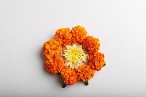 Marigold Flower rangoli Design with green leaf for traditional Festival. photo