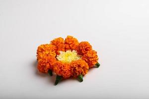 Marigold Flower rangoli Design with green leaf for traditional Festival. photo