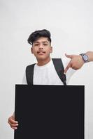 Indian college student showing board on white background. photo