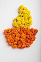 Marigold Flower rangoli Design in oil lamp shape. photo