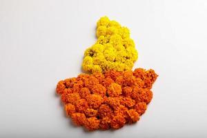 Marigold Flower rangoli Design in oil lamp shape. photo