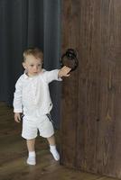 A little boy near the wooden door. photo