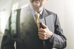 success businessman holding digital tablet computer,front view,filter effect photo