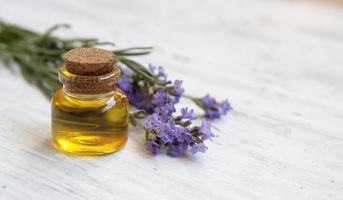 Glass vintage bottle filled with lavender oil. Natural cosmetics, herbal medicine concept photo