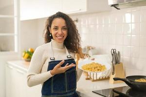 Latin woman cooking in kitchen photo