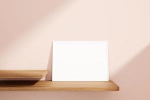 Minimalist and clean horizontal white poster or photo frame mockup on the wooden table leaning against the room wall