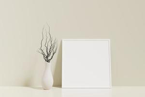 Minimalist and clean square white poster or photo frame mockup on the floor leaning against the room wall with vase