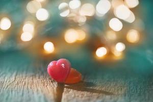 Red heart-shaped candy with bokeh photo