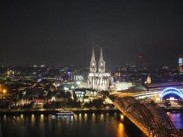 Aerial night view of St Peter Cathedral and Hohenzollern Bridge photo