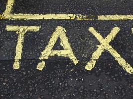 Taxi sign on tarmac photo