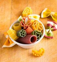 Multicolored italian pasta in bowl photo