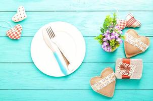 Romantic dinner,flowers and hearts on wooden background. Mock up and copy space photo