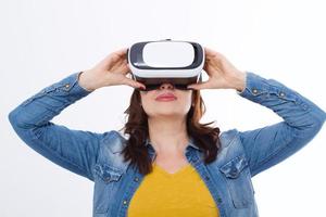 Woman wearing VR headset and looking up in virtual reality isolate on white background. Computer technology. Copy space and mock up. photo