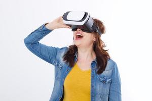 Woman wearing VR headset and looking up in virtual reality isolate on white background. Computer technology. Copy space and mock up. photo