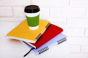 Workspace and education accessories on the table. Cup of coffee, notebooks. Stem education and school background. photo