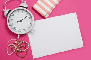 Workspace with copy space. Woman fashion mood board accessories on pink background. Clock and mock up. Top view and teenager desktop. Summer style and template mock up. photo