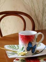 Beauty coffeecup standing on wooden table with dark tasty coffee photo