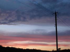 Power electric pole with line wire on colored background close up photo