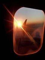 Beautiful view from airplane window, large wing of aircraft shows casement photo