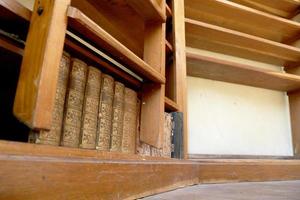 Personal library consisting of big empty bookcase with wooden bookshelf for books photo