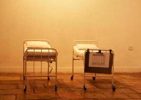 Empty hospital beds standing in abandoned room for patients photo