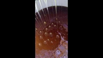 Drop of bee honey drip from hexagonal honeycombs video