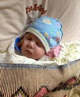 Sleeping baby boy with child pacifier posing photographer for color photo