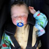 Sleeping baby boy with child pacifier posing photographer for color photo