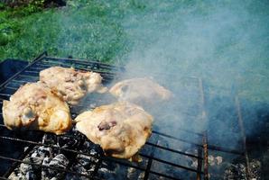 Grilled chicken meat on the grill ready for eating barbeque photo