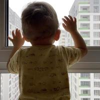 Beautiful baby boy with child face posing photographer near window photo