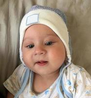 Beautiful baby boy with child hat posing photographer for color photo