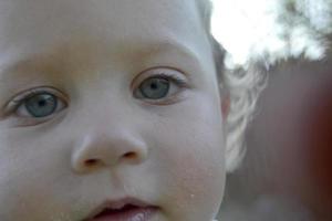 Beautiful baby boy with child face posing photographer for color photo