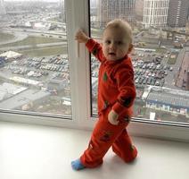 Beautiful baby boy with child face posing photographer near window photo