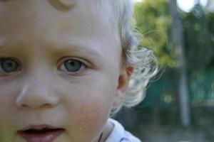 Beautiful baby boy with child face posing photographer for color photo