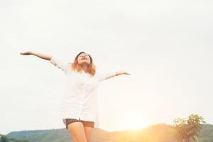 Beautiful women standing raising arm after waking, enjoy with fresh air in the morning. photo